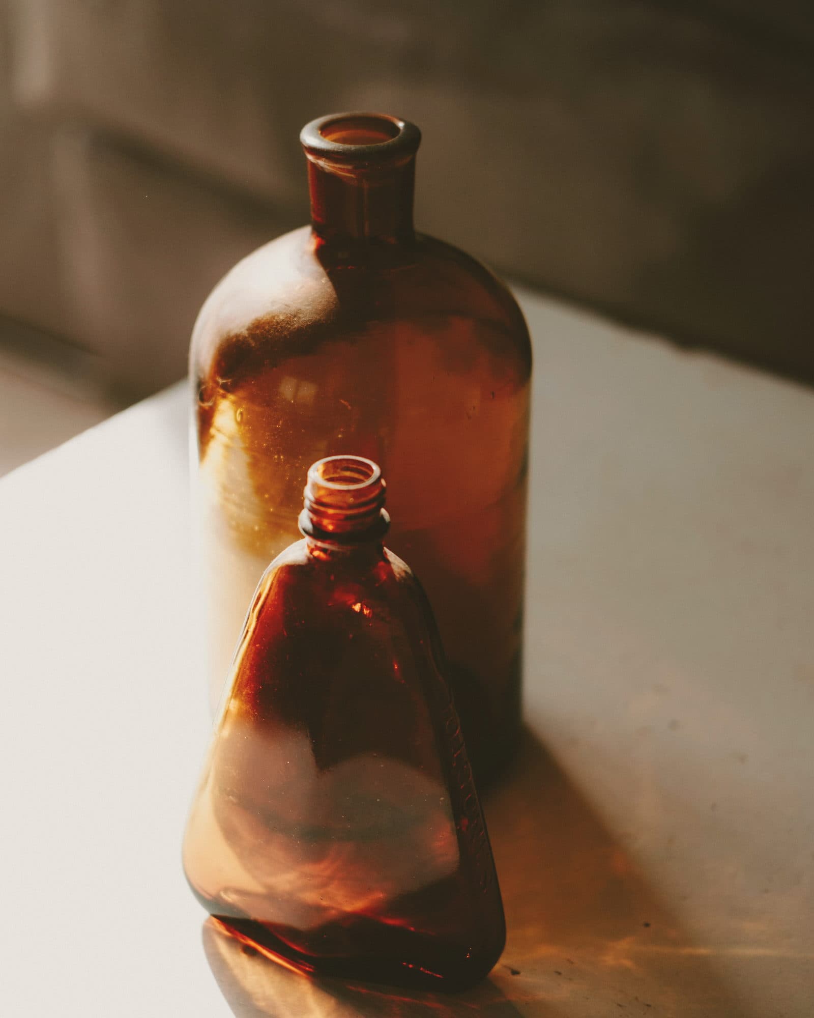 Amber apothecary bottles in afternoon light